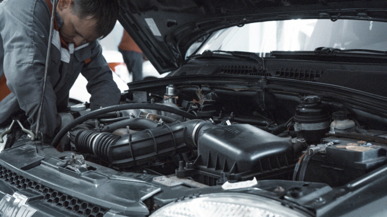 A mechanic repairing a vehicle covered by RAC warranty